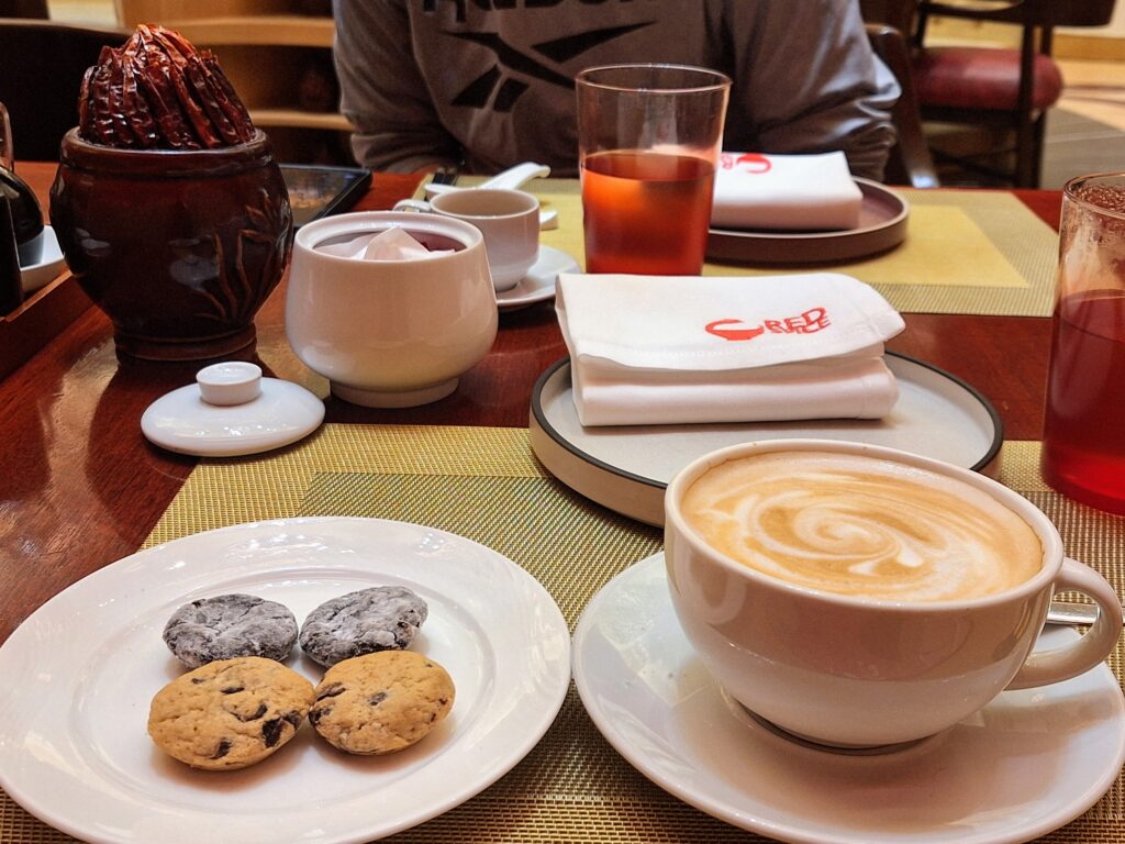 Cafe latte with complimentary cookies at Red Spice Okada Manila 