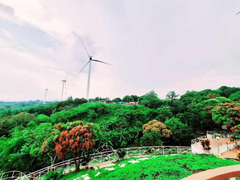 Pililla Wind Farm wind turbines above green hills in Pililla, Rizal, with the viewing deck in the foreground