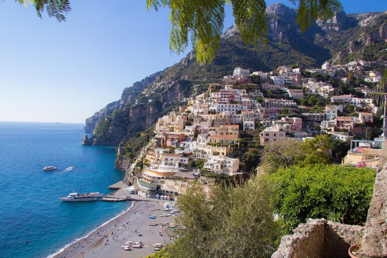 Amalfi Coast itinerary view of Positano's colorful cliffside houses above the sea