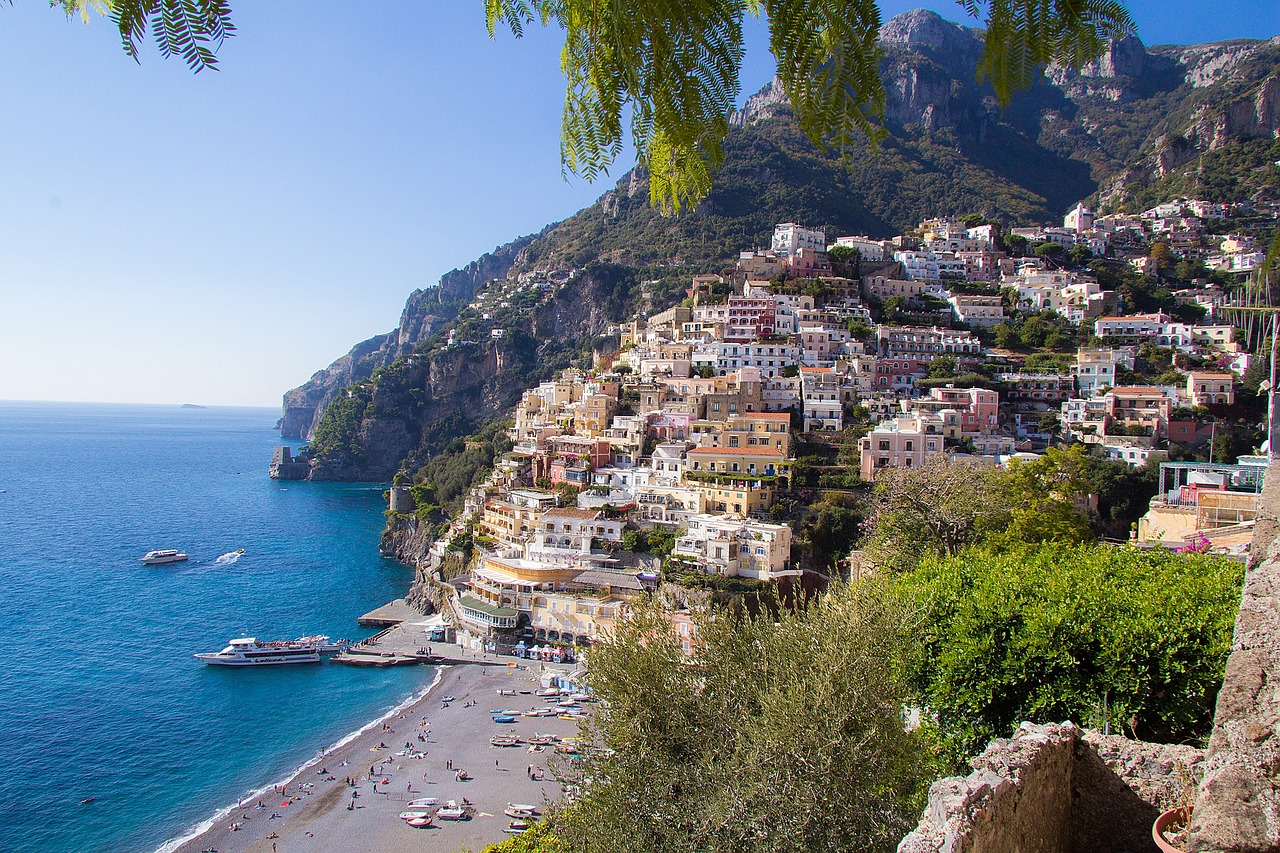 Amalfi Coast itinerary view of Positano's colorful cliffside houses above the sea
