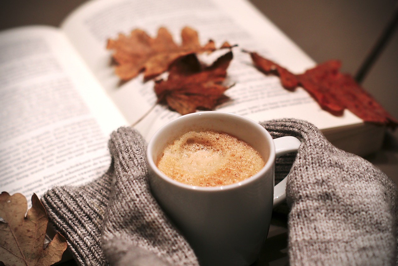The Soulmate Equation by Christina Lauren — a warm drink beside an open book with autumn leaves