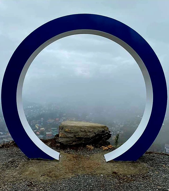 The round Blue Moon Gate framing a misty view at Mirador Heritage and Eco-Spirituality Park in Baguio City