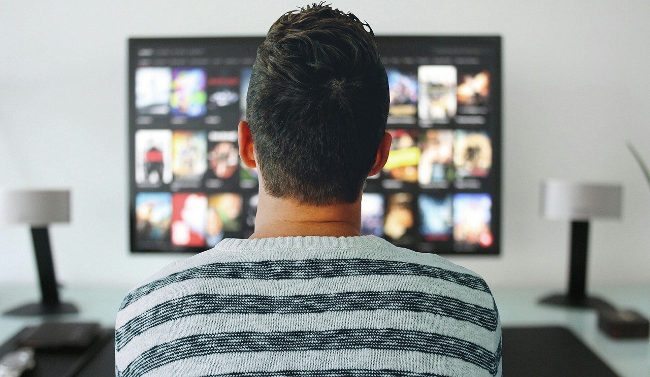 Book Adaptations - a man watching epic book adaptations on TV