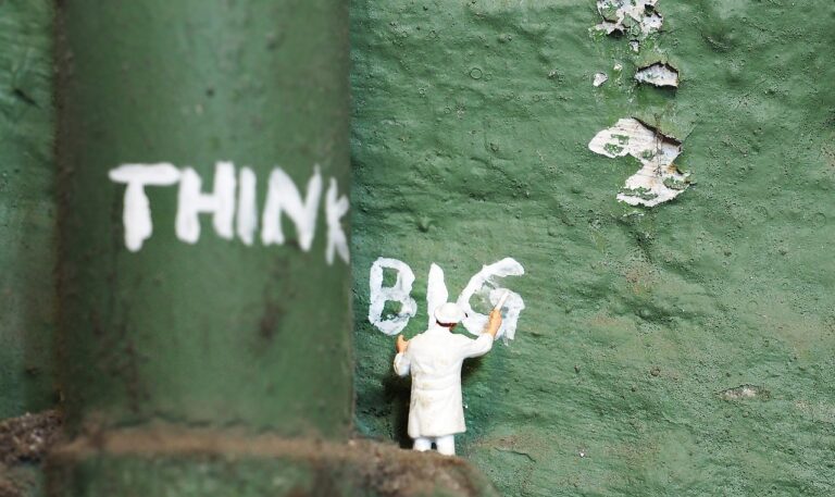 Tiny painter writing THINK BIG on a green wall — Think and Grow Rich by Napoleon Hill