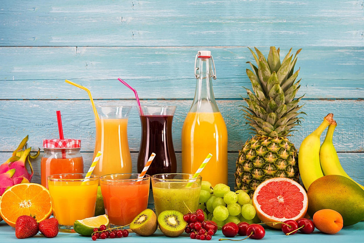 Tropical fruit juice glasses with pineapple, mango and fresh tropical fruits