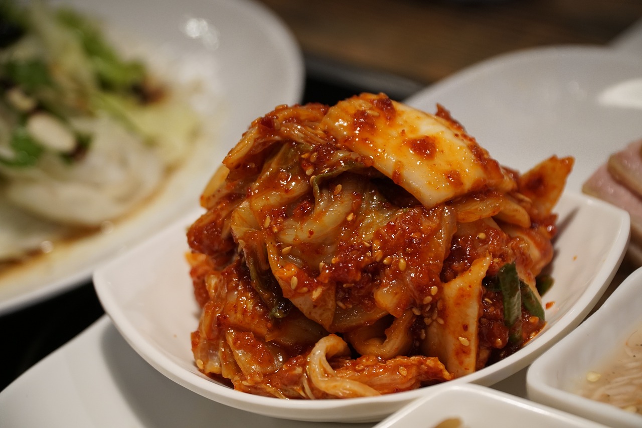 Homemade kimchi served in a small white bowl, ready to eat