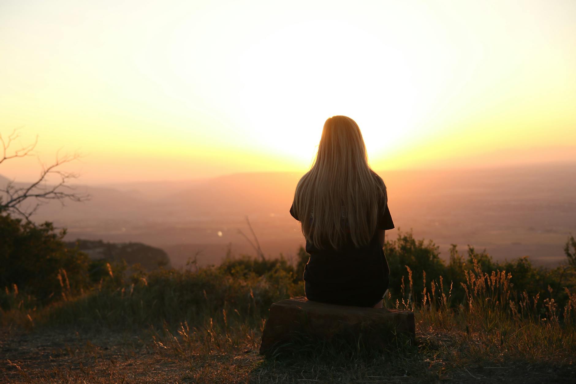 Taeyeon songs for heartbreak – a woman listening at sunset