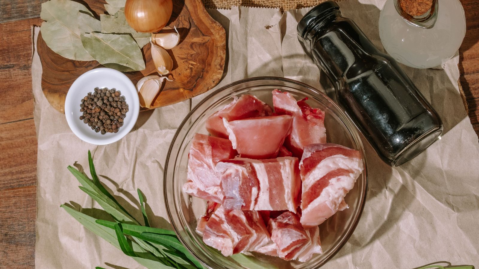 Ingredients for Filipino pork belly adobo: pork belly, soy sauce, vinegar, garlic, bay leaves, and black peppercorns