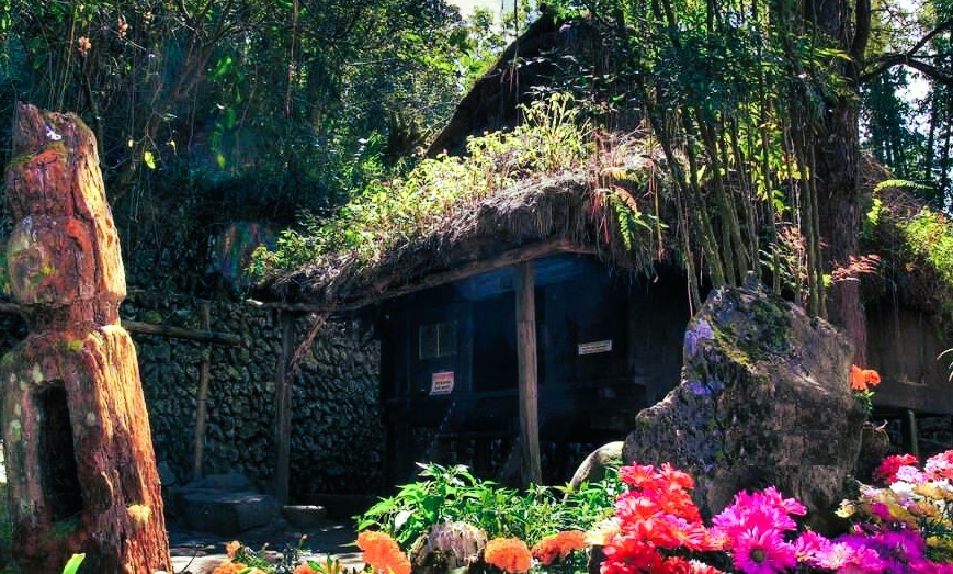 A traditional Ifugao hut in a forest clearing at Tam-awan Village in Baguio City