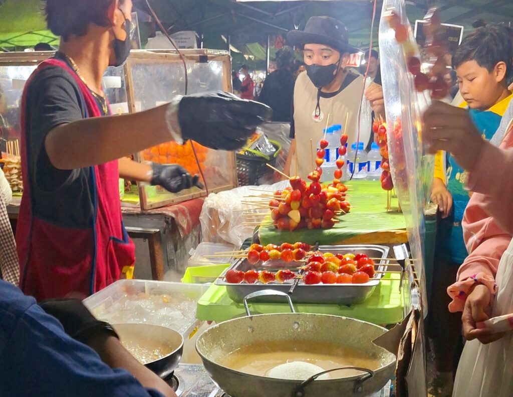 A street food stall at the Baguio night market serving grilled skewers and snacks to shoppers